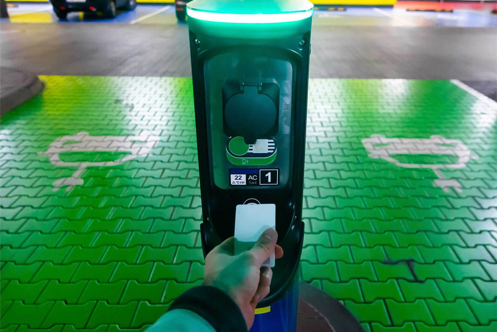 a-man-pays-for-charging-an-electric-car-hand-holdi-GCRVMP4.jpg